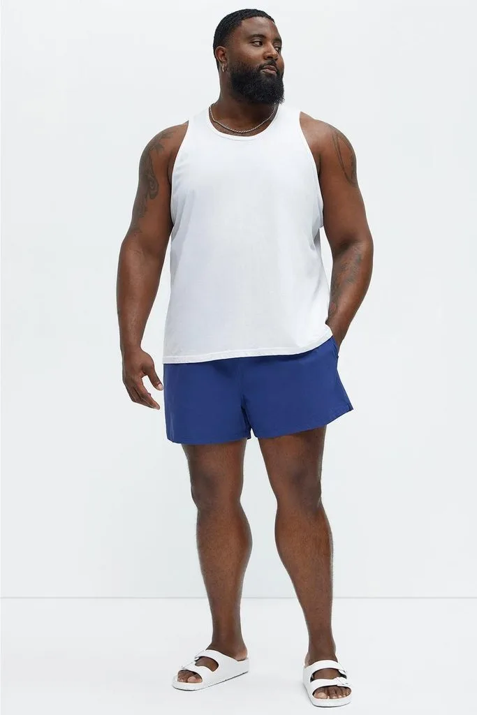 Bright Swim Trunks and a Neutral Tank Top